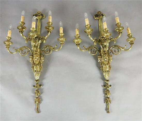 A pair of late Victorian ornate cast brass five branch wall lights, width 22in. depth 11in. height 39in.